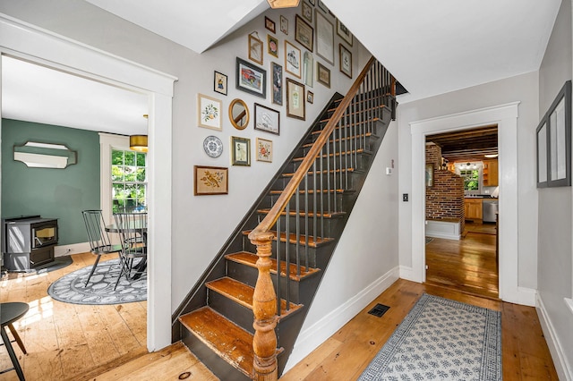 8 Main St, Brookline, NH 03033 - staircase with hardwood / wood-style floors and a wood stove