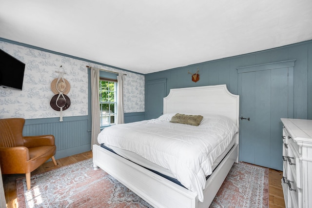 8 Main St, Brookline, NH 03033 - bedroom featuring light wood finished floors, a wainscoted wall, and wallpapered walls