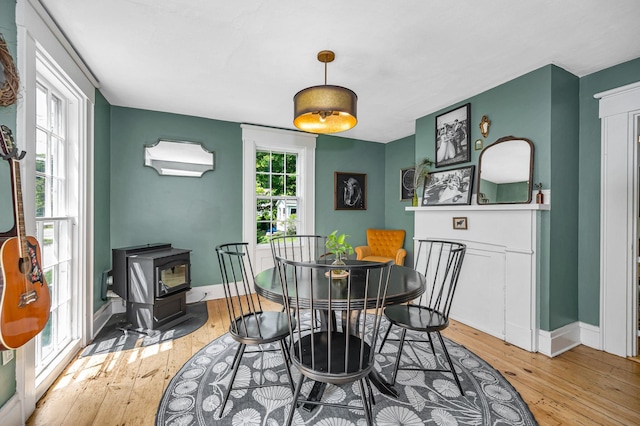 8 Main St, Brookline, NH 03033 - dining area with a wood stove and light wood-style flooring