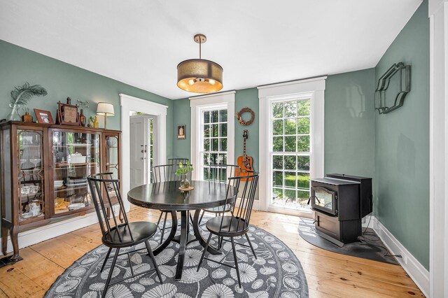 8 Main St, Brookline, NH 03033 - dining area with light wood-type flooring and a wood stove