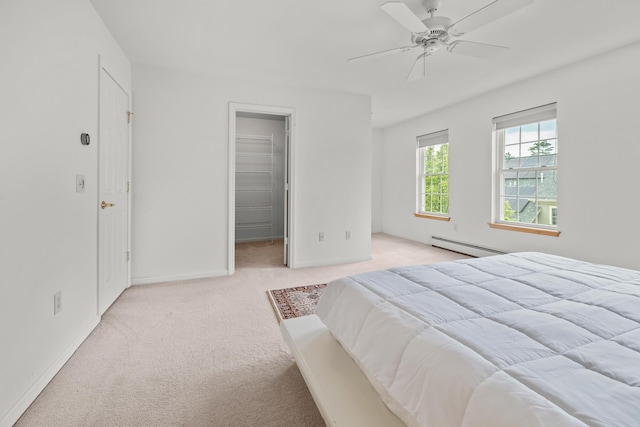 7 Shadow Brook Dr, Hanover, NH 03755 - bedroom with a baseboard radiator, light carpet, a walk in closet, and a ceiling fan
