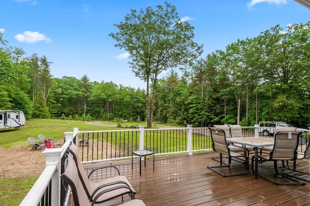 6 Rainbow Dr, Ossipee, NH 03864 - wooden terrace with outdoor dining area, a yard, and a wooded view