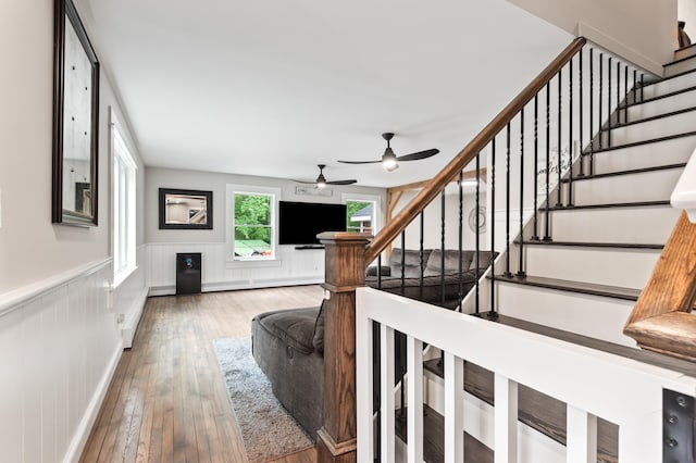 6 Rainbow Dr, Ossipee, NH 03864 - stairs featuring wainscoting, hardwood / wood-style floors, and a ceiling fan
