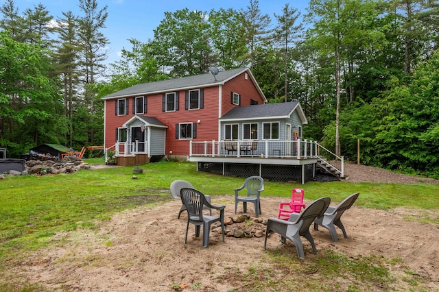 6 Rainbow Dr, Ossipee, NH 03864 - rear view of house featuring a fire pit, a wooden deck, a yard, and view of wooded area