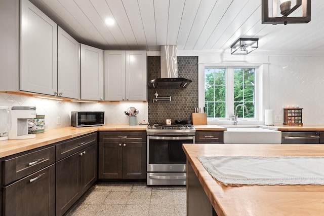 6 Rainbow Dr, Ossipee, NH 03864 - kitchen with wood counters, appliances with stainless steel finishes, wall chimney exhaust hood, backsplash, and wood ceiling