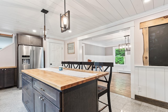 6 Rainbow Dr, Ossipee, NH 03864 - kitchen with wood counters, stainless steel fridge with ice dispenser, a breakfast bar, ornamental molding, and a wainscoted wall
