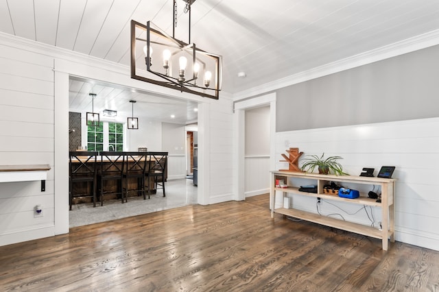 6 Rainbow Dr, Ossipee, NH 03864 - dining space with wood finished floors, crown molding, and a chandelier