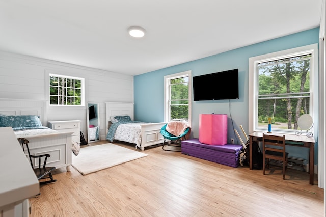 6 Rainbow Dr, Ossipee, NH 03864 - bedroom with multiple windows, wood finished floors, and wood walls