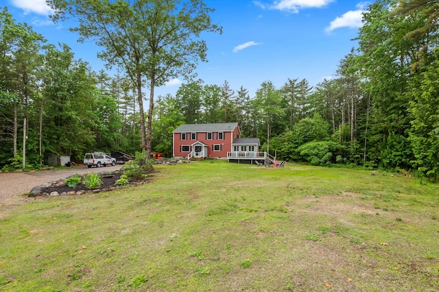 6 Rainbow Dr, Ossipee, NH 03864 - view of grassy yard featuring a forest view, a deck, and driveway