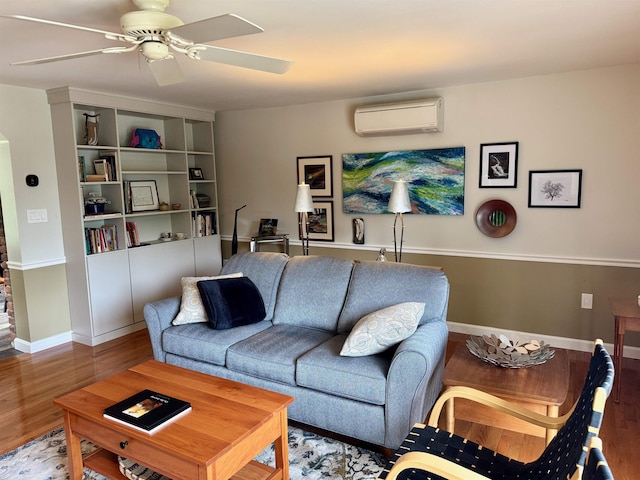 653 Skyboro E Rd, Pownal, VT 05261 - living room with an AC wall unit, a ceiling fan, and wood finished floors