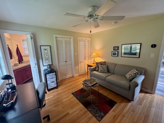 653 Skyboro E Rd, Pownal, VT 05261 - living room featuring light wood finished floors, a ceiling fan, and an office area