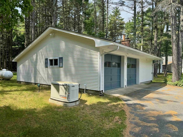 653 Skyboro E Rd, Pownal, VT 05261 - view of property exterior featuring a chimney, a garage, a lawn, and view of wooded area
