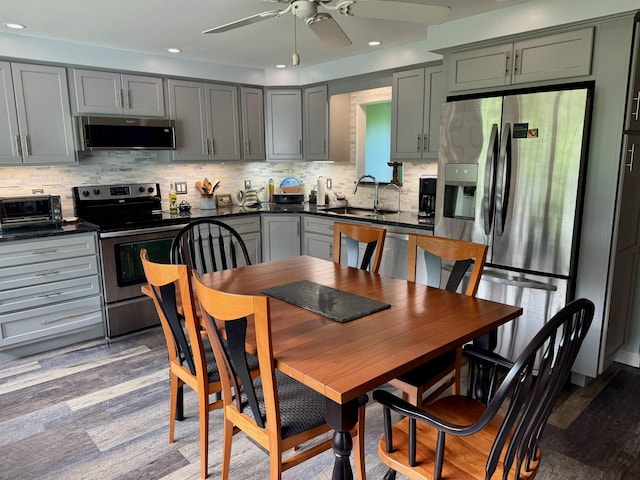 653 Skyboro E Rd, Pownal, VT 05261 - kitchen featuring appliances with stainless steel finishes, dark countertops, a ceiling fan, tasteful backsplash, and recessed lighting