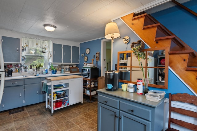 3123 Carter Hill Rd, Highgate, VT 05488 - kitchen featuring stainless steel microwave, light countertops, and crown molding