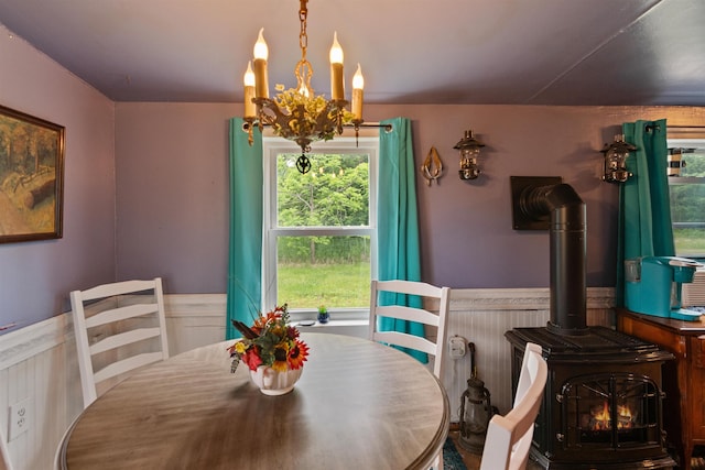 3123 Carter Hill Rd, Highgate, VT 05488 - dining room with a wood stove, wainscoting, and a chandelier