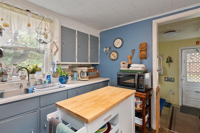 3123 Carter Hill Rd, Highgate, VT 05488 - kitchen featuring stainless steel microwave, gray cabinetry, wooden counters, ornamental molding, and carpet floors