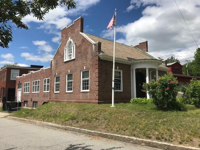 18 Bridge St, Rockingham, VT 05101 - view of side of property with brick siding and a lawn