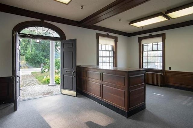 18 Bridge St, Rockingham, VT 05101 - carpeted foyer with radiator heating unit, wainscoting, and beam ceiling