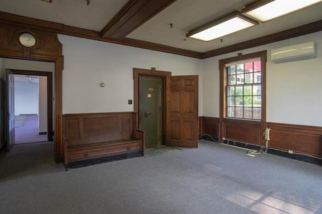 18 Bridge St, Rockingham, VT 05101 - empty room with a wall unit AC, carpet flooring, wainscoting, and ornamental molding
