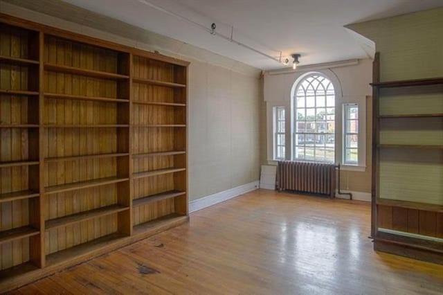 18 Bridge St, Rockingham, VT 05101 - empty room featuring radiator and wood finished floors