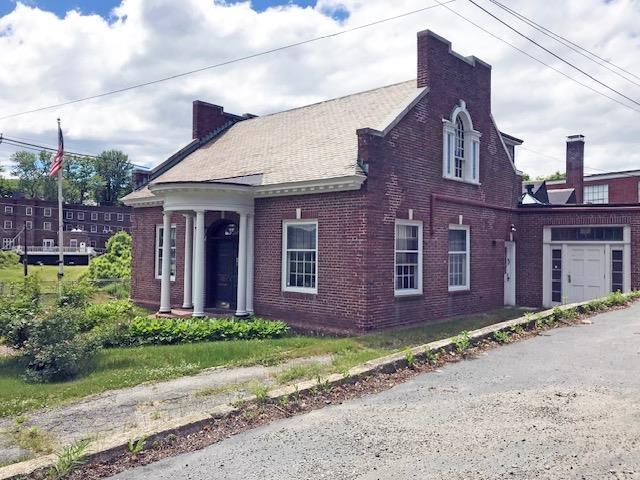 18 Bridge St, Rockingham, VT 05101 - view of front of house featuring brick siding and a chimney