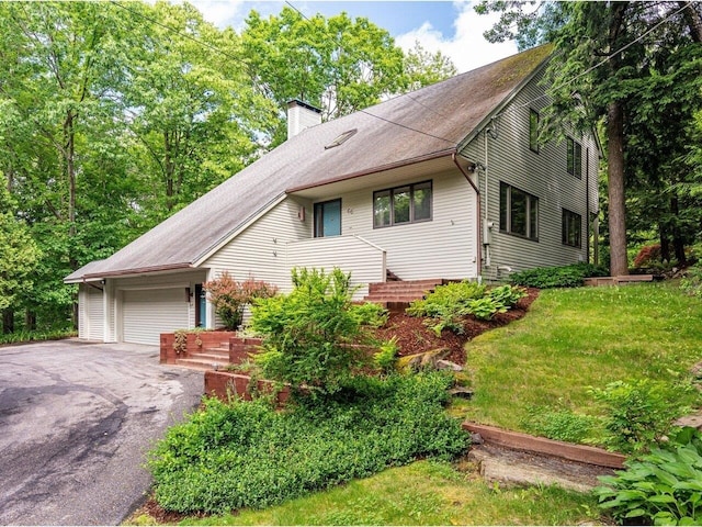 66 Dunder Rd, Burlington, VT 05401 - view of front facade featuring a chimney, asphalt driveway, and an attached garage