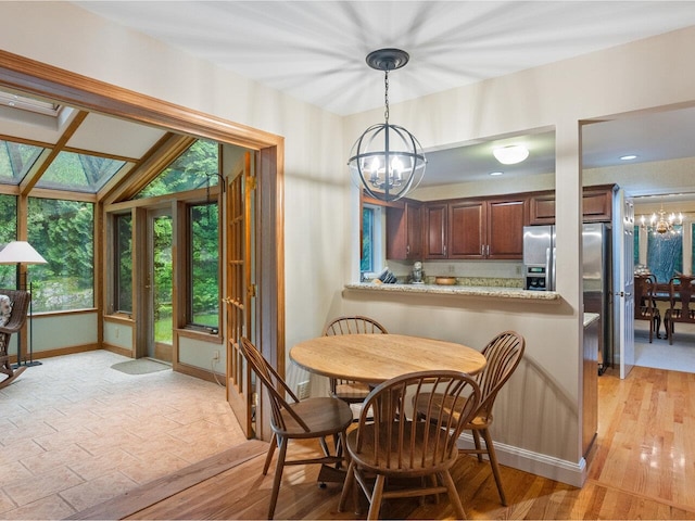 66 Dunder Rd, Burlington, VT 05401 - dining area with a chandelier and a skylight