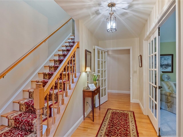 66 Dunder Rd, Burlington, VT 05401 - entrance foyer featuring french doors, light wood finished floors, and stairway