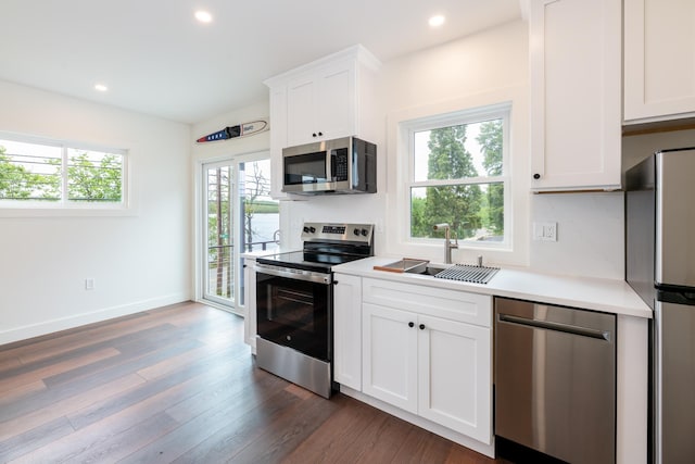 427 Weirs Blvd Unit 3, Laconia, NH 03246 - kitchen with stainless steel appliances, light countertops, recessed lighting, dark wood-style floors, and white cabinetry