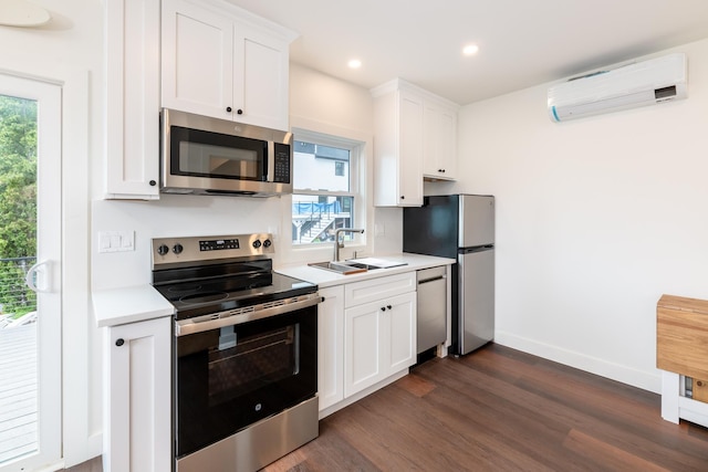 427 Weirs Blvd Unit 3, Laconia, NH 03246 - kitchen with appliances with stainless steel finishes, a wall mounted air conditioner, light countertops, dark wood finished floors, and white cabinets