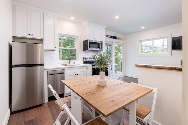 427 Weirs Blvd Unit 3, Laconia, NH 03246 - kitchen with stainless steel appliances, white cabinets, dark wood-style flooring, plenty of natural light, and recessed lighting