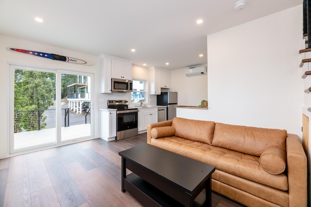 427 Weirs Blvd Unit 3, Laconia, NH 03246 - living area featuring healthy amount of natural light, wood finished floors, recessed lighting, and a wall mounted air conditioner