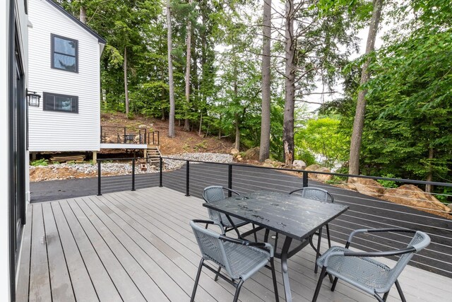 427 Weirs Blvd Unit 3, Laconia, NH 03246 - deck featuring outdoor dining area, view of scattered trees, and stairway