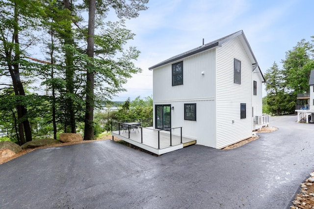 427 Weirs Blvd Unit 3, Laconia, NH 03246 - back of property featuring a wooden deck and asphalt driveway