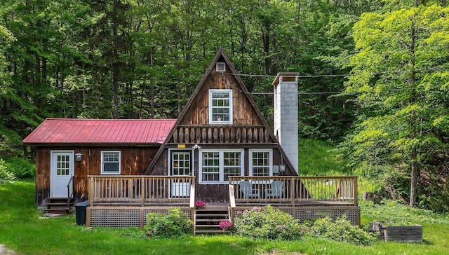 7271 Windham Hill Rd, Windham, VT 05359 - rear view of house featuring a chimney, a wooded view, a metal roof, a wooden deck, and board and batten siding