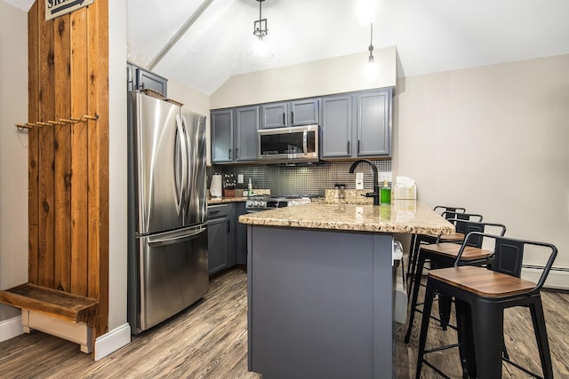 267 Village Cir Unit V-15, Killington, VT 05751 - kitchen with stainless steel appliances, a peninsula, decorative backsplash, gray cabinets, and wood finished floors