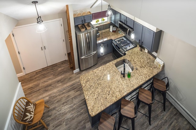 267 Village Cir Unit V-15, Killington, VT 05751 - kitchen featuring dark wood-style flooring, stainless steel appliances, a kitchen bar, a baseboard heating unit, and a peninsula