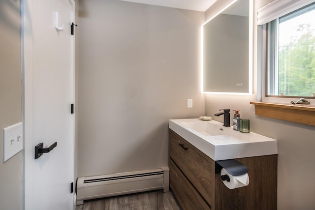 267 Village Cir Unit V-15, Killington, VT 05751 - bathroom featuring a baseboard heating unit, vanity, and wood finished floors