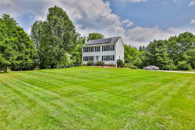 9 Mountain Rd, Goffstown, NH 03045 - colonial home featuring roof mounted solar panels and a front yard