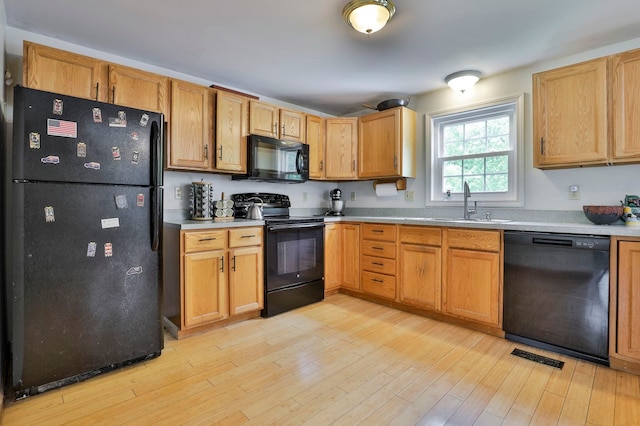 9 Mountain Rd, Goffstown, NH 03045 - kitchen with black appliances, light countertops, and light wood-style flooring