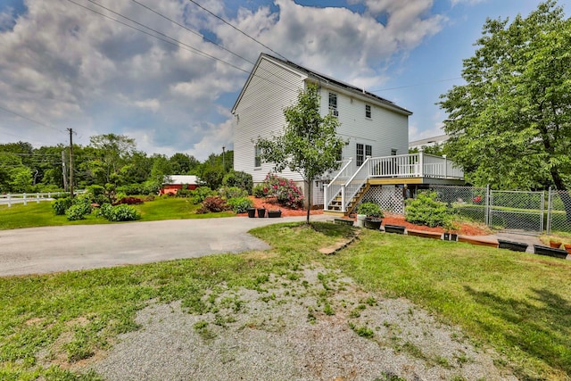 9 Mountain Rd, Goffstown, NH 03045 - rear view of property featuring a wooden deck, concrete driveway, and stairway