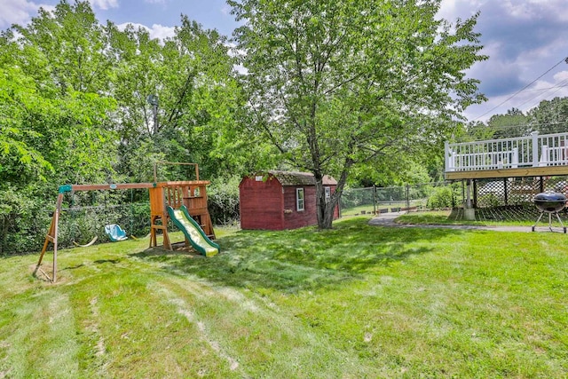 9 Mountain Rd, Goffstown, NH 03045 - fenced backyard featuring a storage unit, a playground, a deck, and view of scattered trees