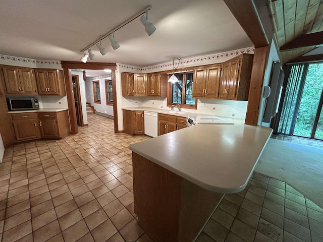 12 Juniper Ridge Rd, Exeter, NH 03833 - kitchen featuring stainless steel microwave, dishwasher, rail lighting, a peninsula, and brown cabinetry