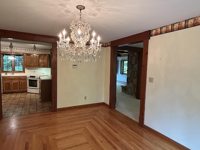 12 Juniper Ridge Rd, Exeter, NH 03833 - unfurnished dining area featuring a chandelier and baseboard heating