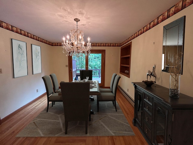 12 Juniper Ridge Rd, Exeter, NH 03833 - dining room featuring baseboard heating, a chandelier, wood finished floors, and built in shelves