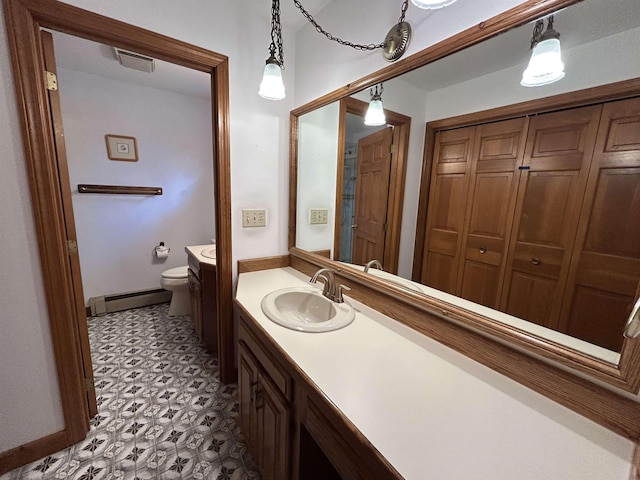 12 Juniper Ridge Rd, Exeter, NH 03833 - bathroom featuring baseboard heating, vanity, and tile patterned floors