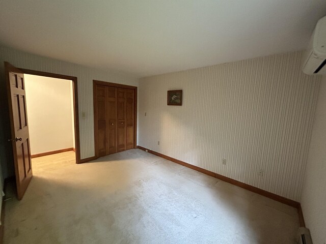 12 Juniper Ridge Rd, Exeter, NH 03833 - unfurnished bedroom featuring a closet, carpet, a wall unit AC, and wallpapered walls