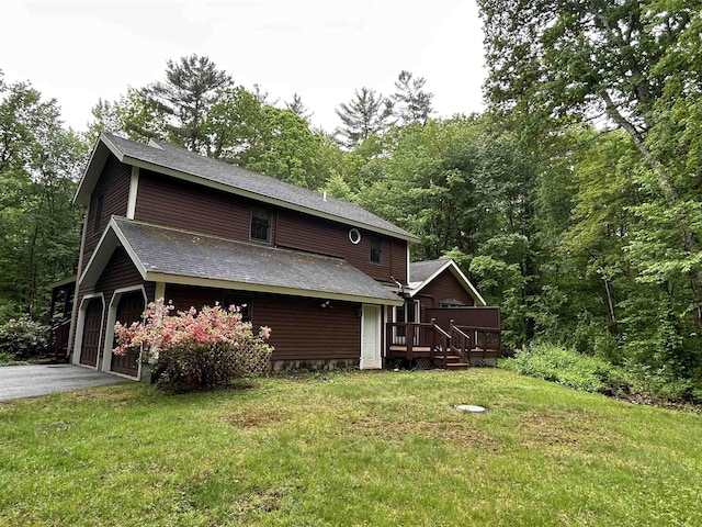 12 Juniper Ridge Rd, Exeter, NH 03833 - view of side of home with a wooden deck, asphalt driveway, a lawn, and a shingled roof