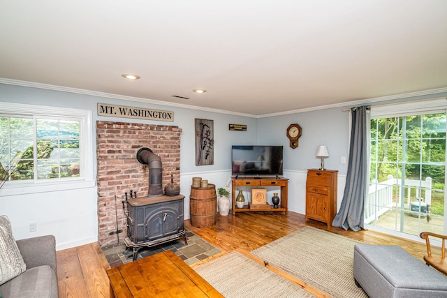 435 Rolling Ridge Rd, Bartlett, NH 03812 - living room with healthy amount of natural light, wood finished floors, crown molding, a wood stove, and recessed lighting