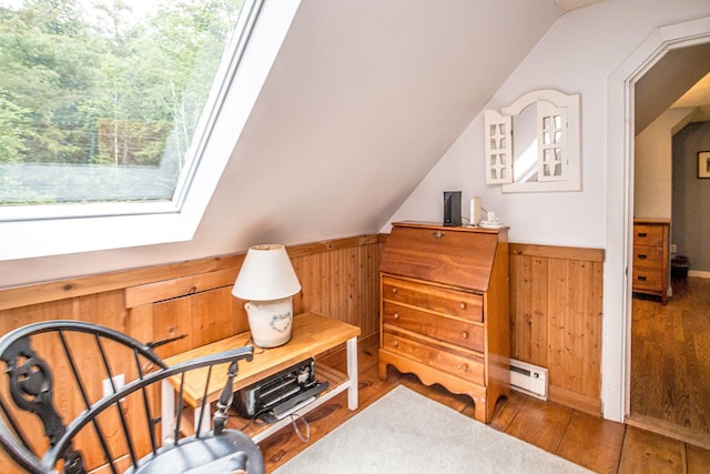 435 Rolling Ridge Rd, Bartlett, NH 03812 - living area featuring baseboard heating, wood walls, wainscoting, wood finished floors, and lofted ceiling